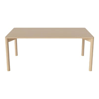 Beige rectangular table with a smooth surface and minimalist design, featuring four straight legs.