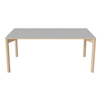 Gray tabletop with a smooth finish and light wooden legs, creating a modern and minimalist aesthetic.