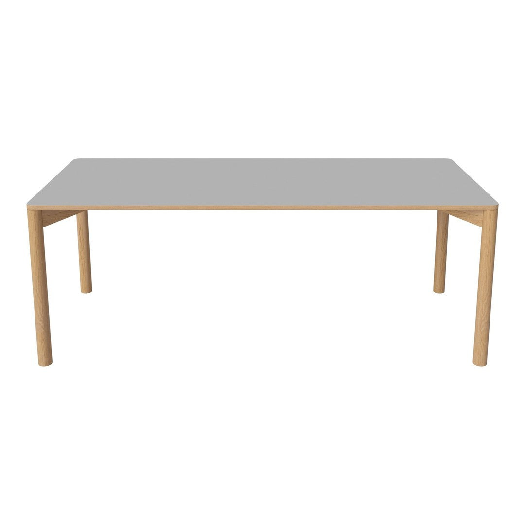 Modern rectangular dining table with a sleek grey top and natural wood legs, perfect for contemporary spaces.