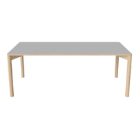 Gray rectangular table with light wooden legs, featuring a sleek, minimalist design and smooth surface.