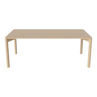 Rectangle dining table in a smooth beige finish, featuring minimalist design with no patterns. Perfect for modern decor.