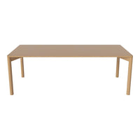 Plain beige dining table with smooth surface and clean lines, perfect for modern or minimalist decor.