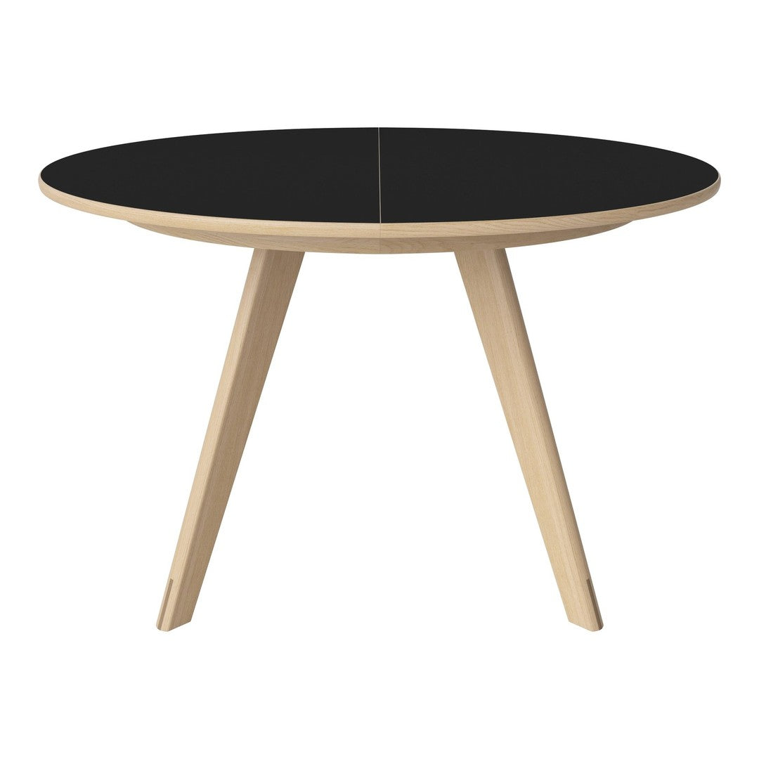 Black round table with wood legs, featuring a sleek and modern design perfect for contemporary spaces.