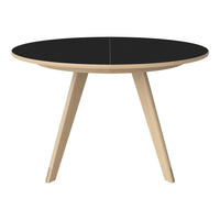 Black round table with wood legs, featuring a sleek and modern design perfect for contemporary spaces.