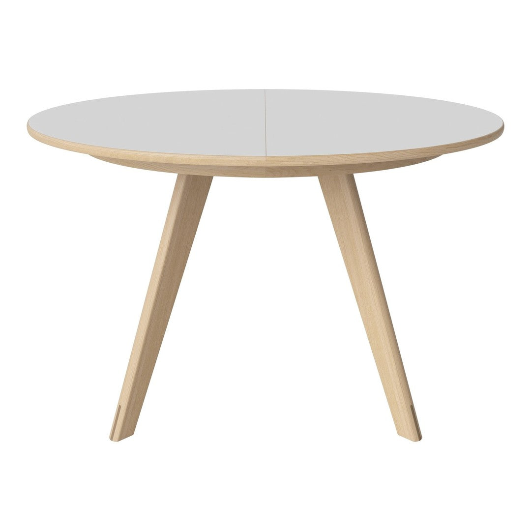 Round white table with natural wood legs, sleek and modern design, perfect for any minimalist decor.