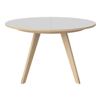 Round white table with natural wood legs, sleek and modern design, perfect for any minimalist decor.