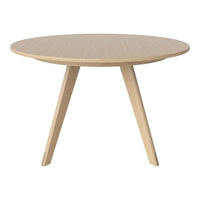 Round wooden table with a light beige finish and subtle, natural wood grain pattern. Elegant, modern design.