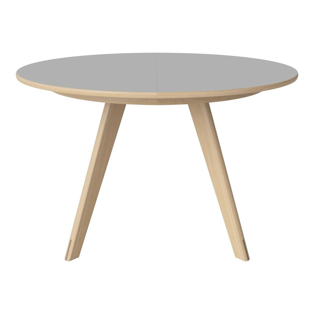Round table with a smooth gray top and natural wood legs, showcasing a minimalist design and contemporary aesthetic.