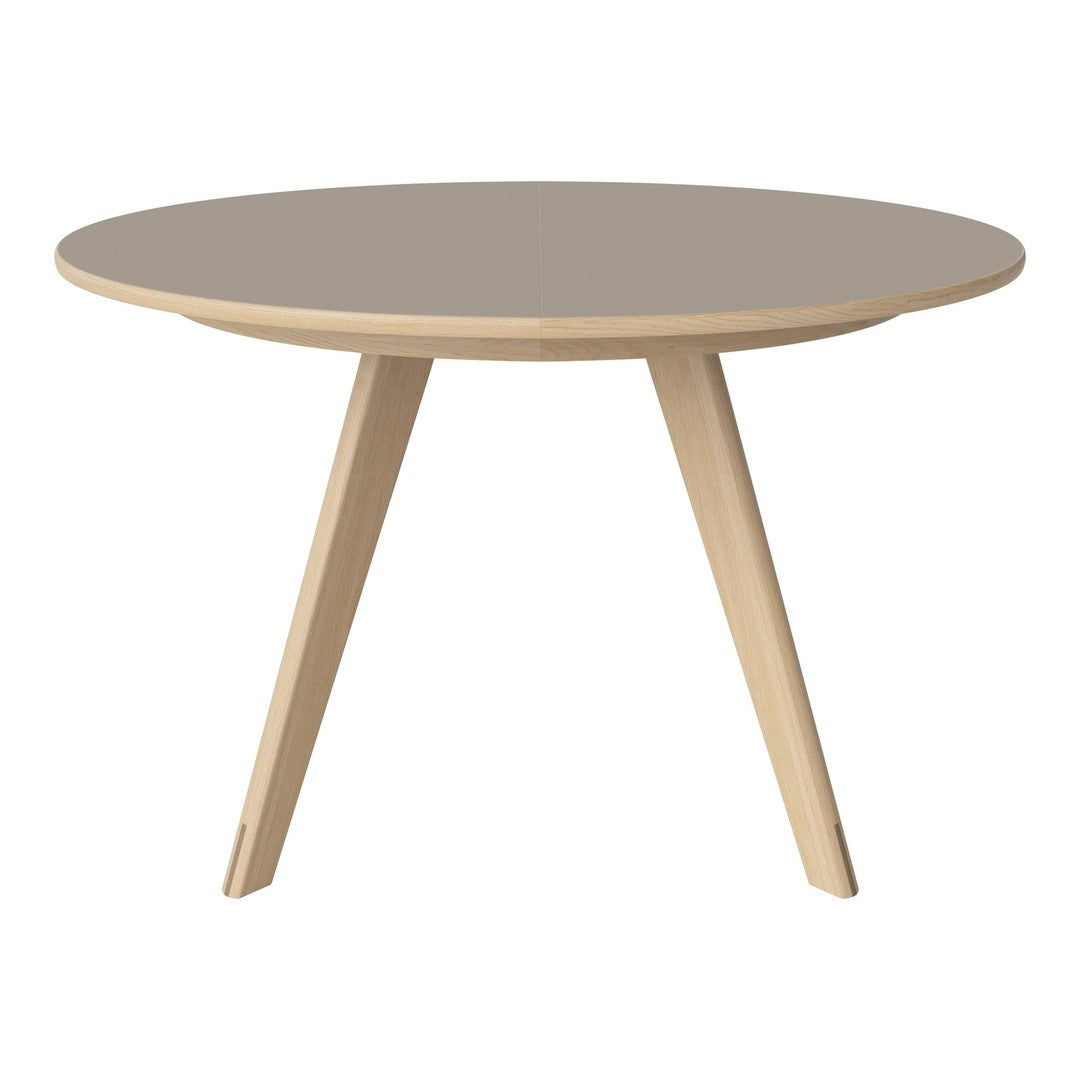 Round coffee table with a soft taupe top and natural wood legs, featuring a modern minimalist design.