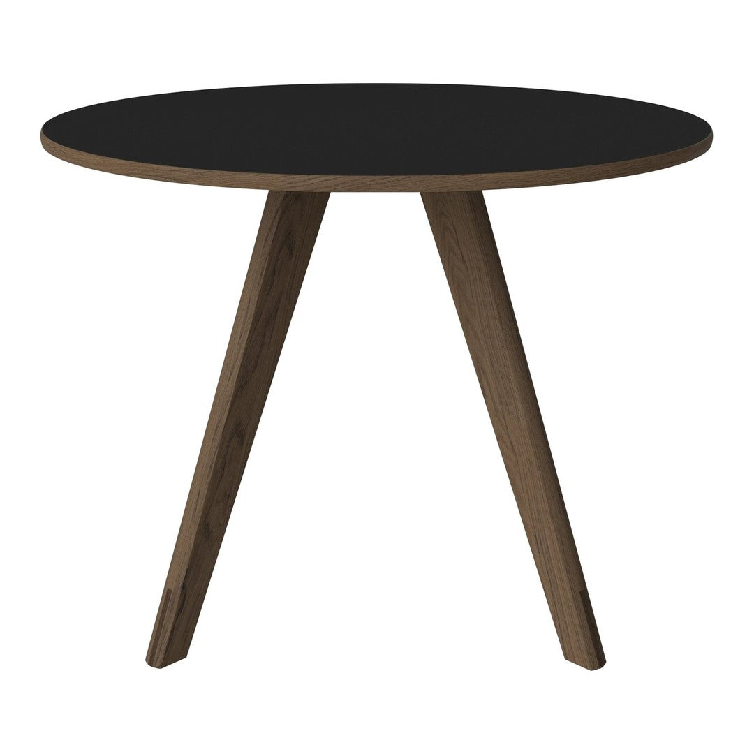 Round black tabletop with natural wood legs, featuring a sleek, modern design. Perfect for contemporary decor.