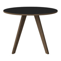 Round black tabletop with natural wood legs, featuring a sleek, modern design. Perfect for contemporary decor.