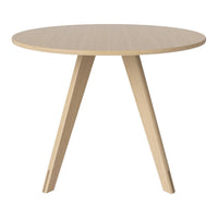 Natural wood round table with a light beige finish and simple, modern pattern in a minimalist design.