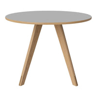 Round gray tabletop with natural wood legs, showcasing a minimalist and modern design. Perfect for any decor.