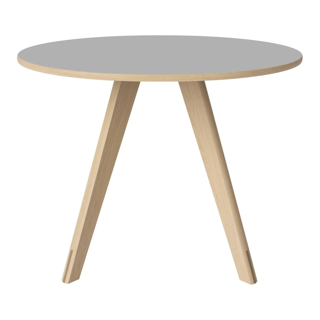 Round table with a sleek gray top and natural wood legs, featuring a minimalist design. Perfect for modern interiors.