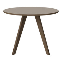 Round table with a smooth taupe top and dark wood tapered legs, ideal for modern or minimalist decor.