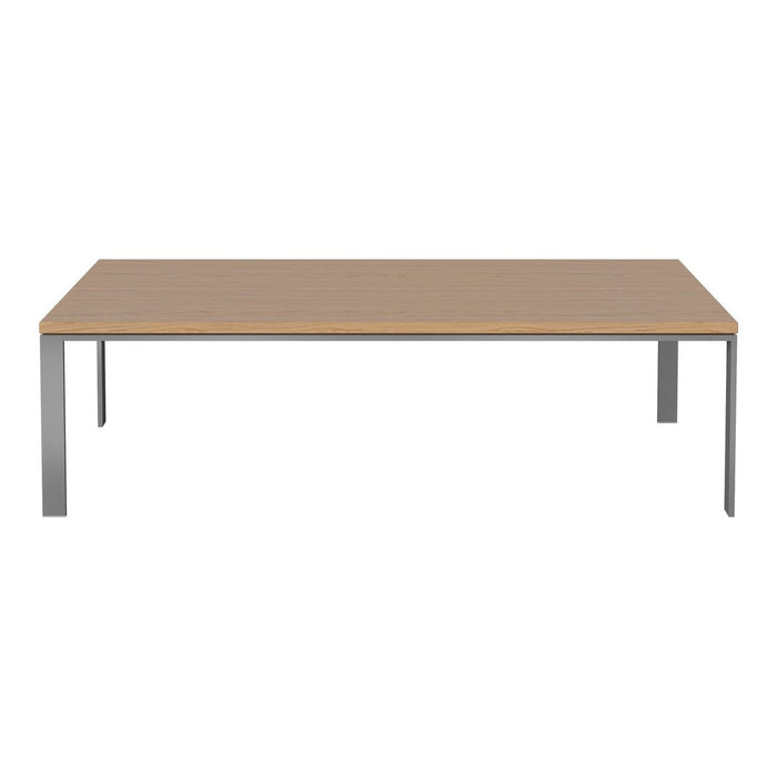 Modern rectangular table with a light wood surface and sleek silver metal legs, perfect for contemporary decor.