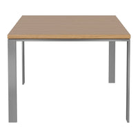 Light wood tabletop with smooth finish and sleek silver metal legs. Simple, modern design emphasizes minimalism.