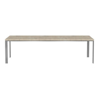 "Long rectangular dining table with a light beige patterned top and sleek silver metal legs."