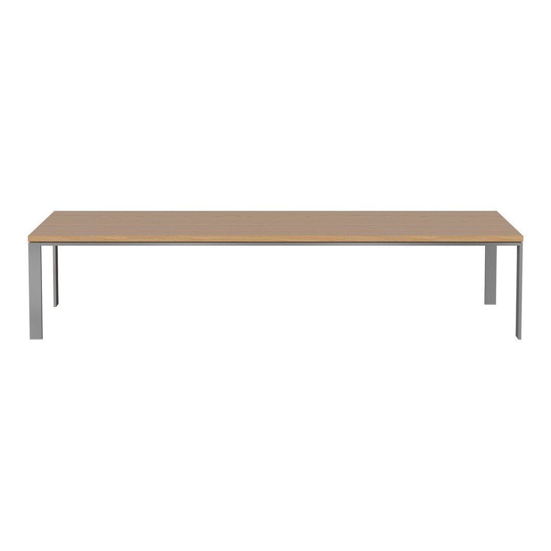 Modern rectangular table with a light wood finish and sleek silver metal legs, showcasing a minimalist design.