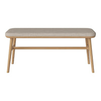 Beige upholstered bench with natural wood legs, featuring a smooth, minimalist design. Perfect for modern interiors.