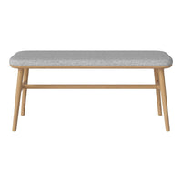 Grey upholstered bench with a smooth surface and natural wood legs, perfect for modern decor.