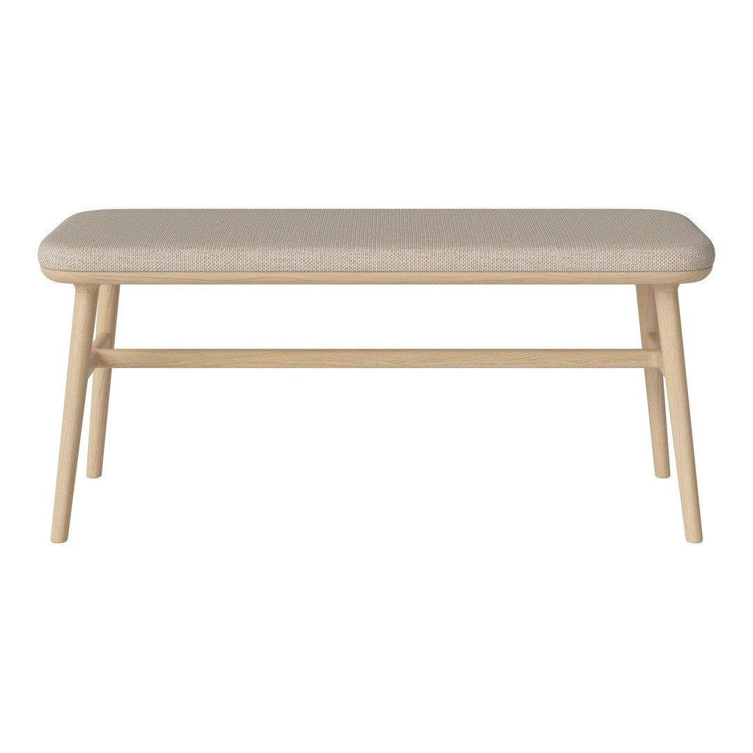 Light beige upholstered coffee table with natural wood legs and a simple, modern design. Ideal for contemporary decor.
