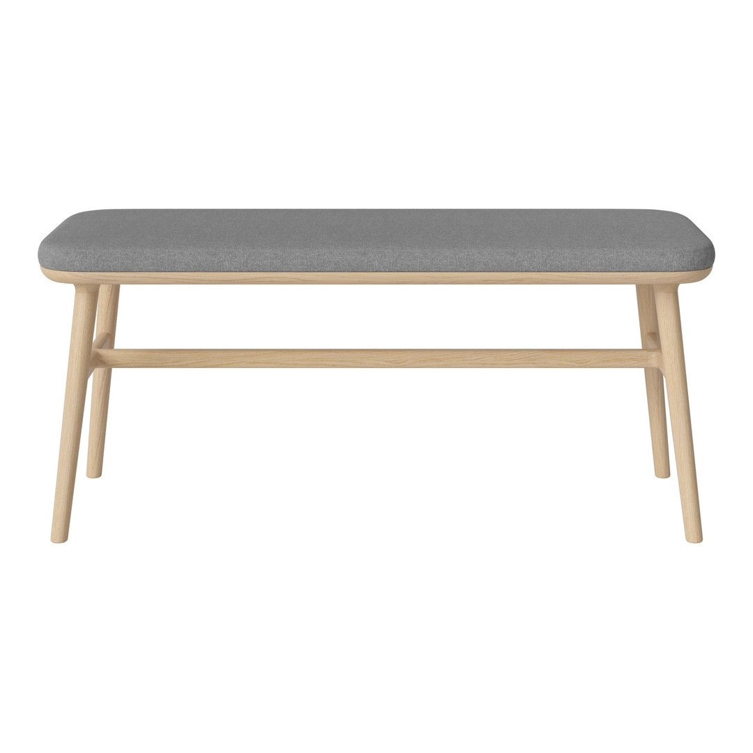 Gray upholstered bench with a smooth, minimalist design and light wood legs. Perfect for modern decor.