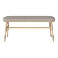 Light wood bench with a soft, textured gray cushion, featuring a minimalist design and subtle patterns.
