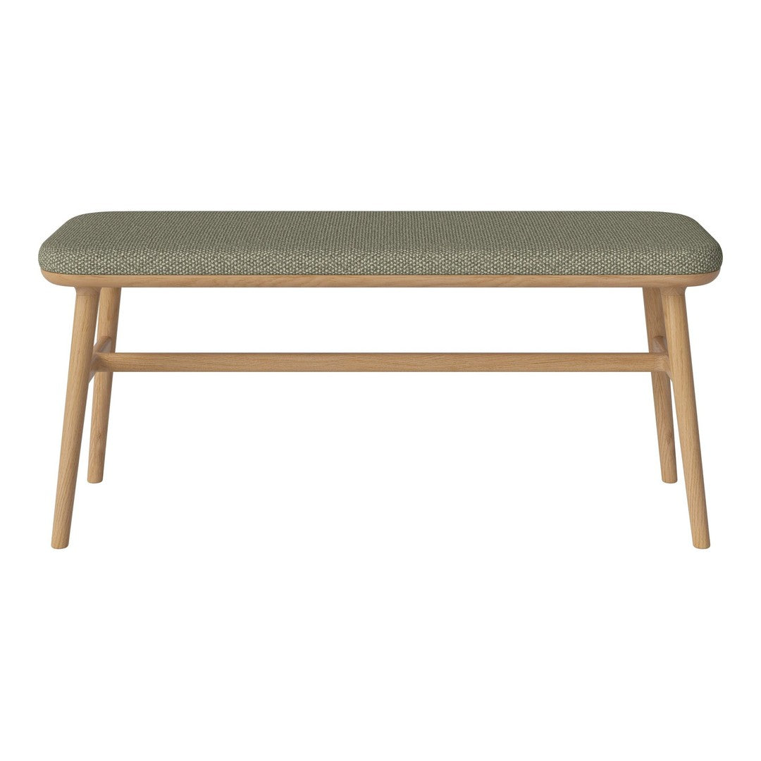 Green patterned cushion atop a light wooden frame, perfect for a stylish accent in any room.