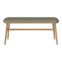 Green patterned cushion atop a light wooden frame, perfect for a stylish accent in any room.