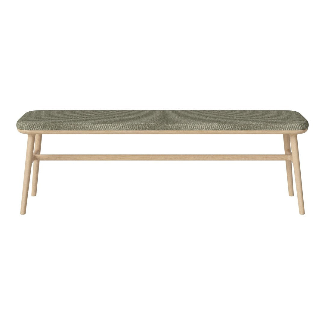 Green upholstered bench with a minimalist design and light wood legs, showcasing a modern and stylish aesthetic.