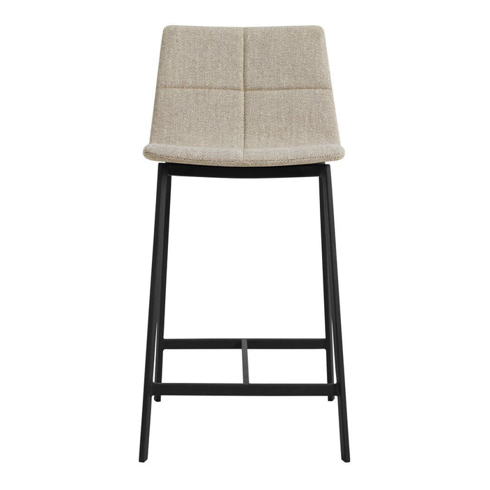 Beige upholstered bar stool with a quilted pattern and sleek black metal frame. Modern neutral color palette.