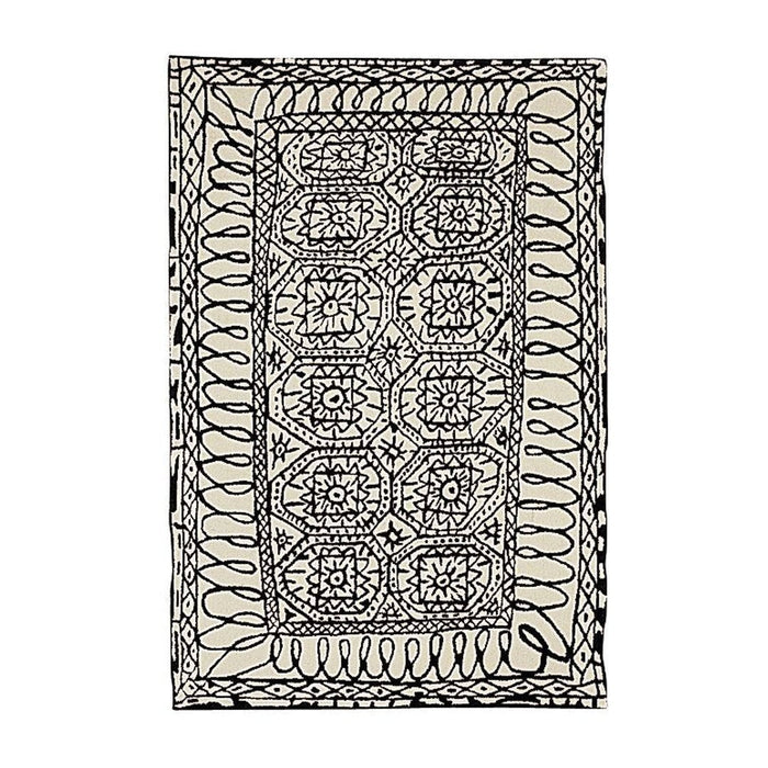 Black and cream geometric patterned rug featuring intricate designs and flowing lines. Perfect for stylish decor.