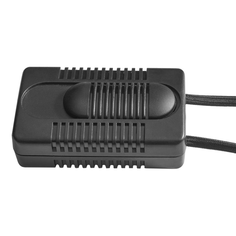 Black rectangular device with ridged surface and a smooth center button, featuring two attached black cords.