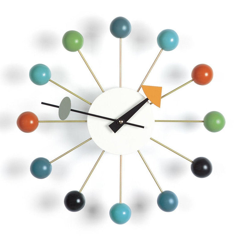 Colorful mid-century wall clock featuring teal, orange, green, black, and gold accents on a white background.