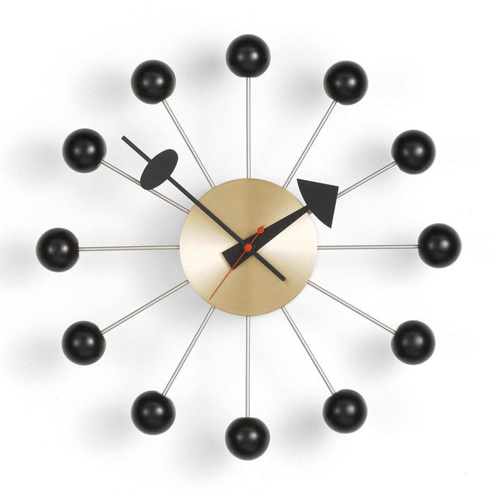Mid-century modern wall clock featuring a gold face, black accents, and red hands against a white background.