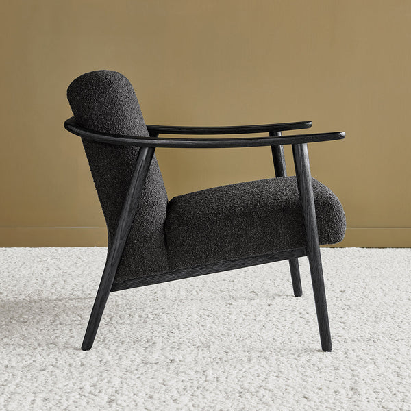 Dark gray textured upholstery with black wooden frame against a warm gold background.