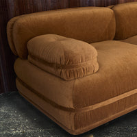 Soft brown velvet sofa with plush cushions and a smooth, modern design. Perfect for cozy living spaces.