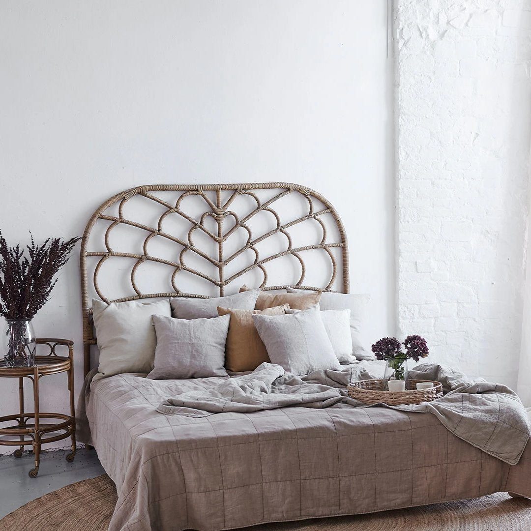Neutral-toned bedding set with textured patterns, complemented by soft beige and earthy accents in a stylish bohemian setting.