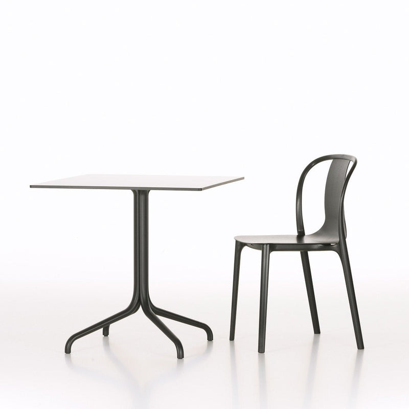 Modern black table and chair set against a minimalistic white background, showcasing sleek lines and contemporary design.