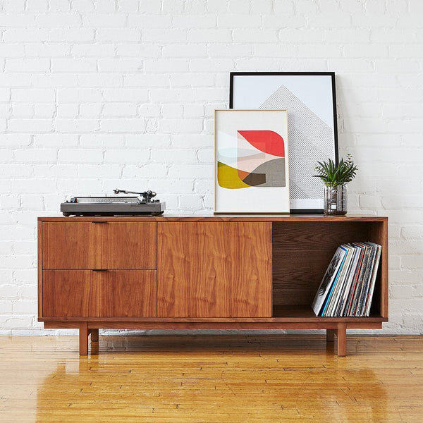Mid-century modern wooden sideboard in rich brown tones, featuring smooth surfaces and geometric patterned decor.