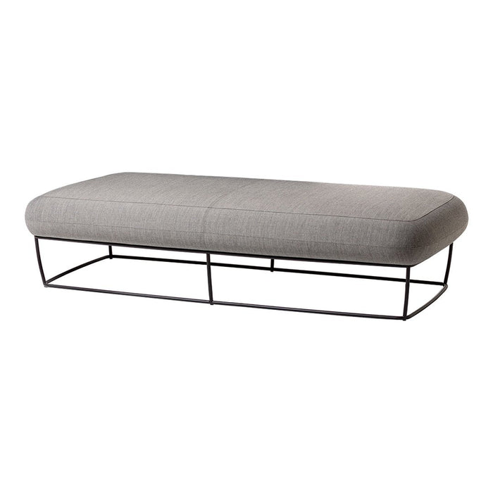 Gray upholstered ottoman with a sleek black metal base, featuring a smooth, minimalist design.