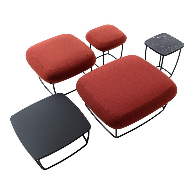 Set of five modern stools featuring bold red and sleek black upholstery with smooth geometric shapes and contrasting wire frames.