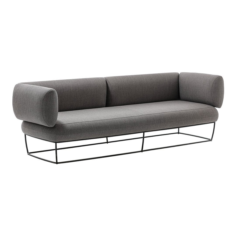 Gray modern sofa with cylindrical armrests and a sleek black metal base. Minimalist design and neutral colors.