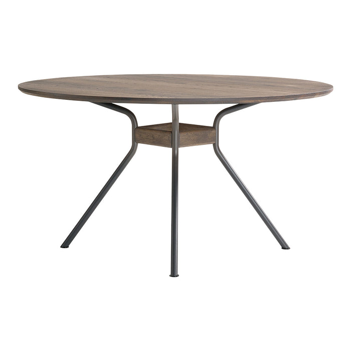 Round wooden dining table with a light brown finish and black metal legs, featuring a sleek, modern design.
