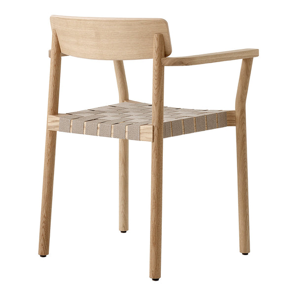 Natural wood chair featuring a light oak finish and woven beige seat pattern. Minimalist design with clean lines.