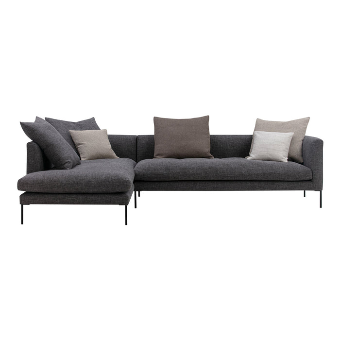 Modern gray sectional sofa with plush, neutral-toned pillows, featuring a sleek design and simple patterns.