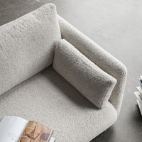 Textured light gray couch with matching pillows, creating a cozy, modern aesthetic for any living space.