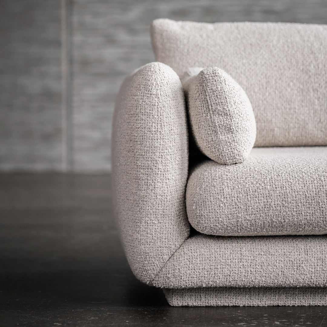 Light beige textured sofa with rounded armrests and a soft, cozy fabric pattern. Perfect for modern interiors.