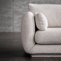 Light beige textured sofa with rounded armrests and a soft, cozy fabric pattern. Perfect for modern interiors.